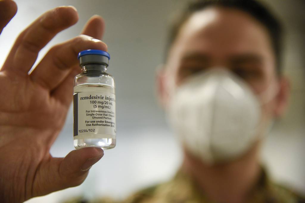 Air Force Airman Robert DuFour holds a vial of Remdesiver, a trial COVID-19 medication, at an undisclosed Strategic National Stockpile warehouse, May 21, 2020.