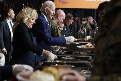 President Joe Biden and first lady Jill Biden serve dinner at Marine Corps Air Station Cherry Point in Havelock, N.C., Monday, Nov. 21, 2022, at a Thanksgiving dinner with members of the military and their families.