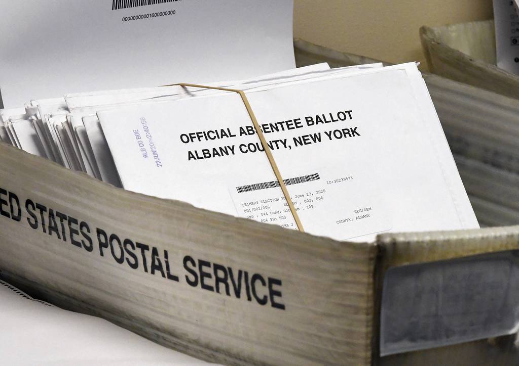 In this June 30, 2020, file photo, a box of absentee ballots wait to be counted at the Albany County Board of Elections in Albany, N.Y.