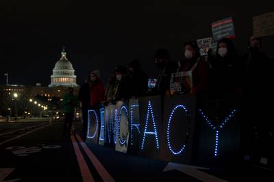 Voting rights activists hold signs near the U.S. Capitol in Washington, D.C., on January 19, 2022.