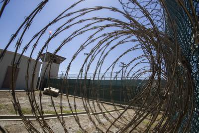 In this April 17, 2019, file photo reviewed by U.S. military officials, the control tower is seen through the razor wire inside the Camp VI detention facility in Guantanamo Bay Naval Base, Cuba.