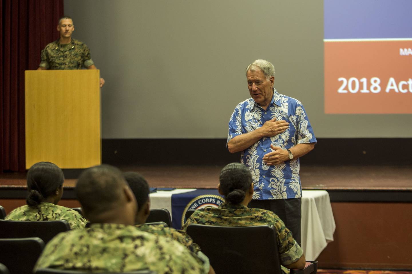 Retired Navy Adm. Steve Abbot, the president of Navy-Marine Corps Relief Society, speaks to service members and families during an Active Duty Fund Drive award ceremony at the base theater at Marine Corps Base Hawaii in 2018.