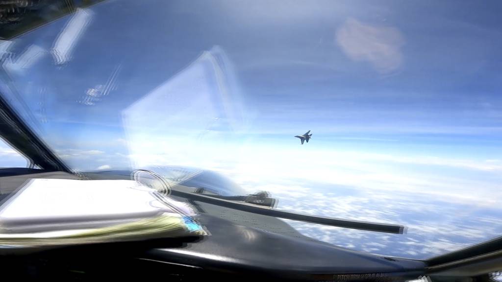 In this image from video provided by the U.S. Navy, a Chinese J-16 fighter flies aggressively close to a U.S. RC-135 aircraft flying in international airspace over the South China Sea on Friday, May 26, 2023.