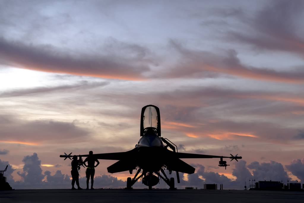 Staff Sgt. Benjamin Preston, 180th Fighter Wing crew chief, and Senior Airman Allison Garcia, 180th FW munitions specialist, stand next to an F-16 Fighting Falcon before morning training flights at Naval Air Station Key West, Fla., Nov. 3, 2022. The 180th FW deployed to Key West to train with Fighter Squadron Composite (VFC-111), the Navy's premier adversary squadron, providing realistic training scenarios that ensure the 180th FW is prepared for homeland defense and contingency operations around the globe. (Staff Sgt. Kregg York/Air National Guard)