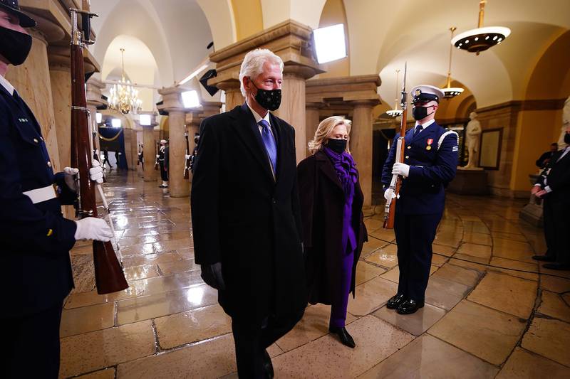 Former President Bill Clinton arrives with former Secretary of State Hillary Clinton before the inauguration of President-elect Joe Biden as the 46th president of the United States on the West Front of the Capitol in Washington on Jan. 20, 2021.