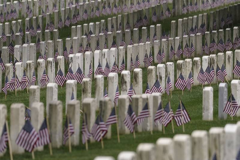 American flags are placed at each headstone in the United States Soldiers' and Airmen's Home National Cemetery ahead of Memorial Day weekend, May 22, 2020, in Washington.