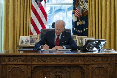 In this Jan. 28, 2021, file photo President Joe Biden signs a series of executive orders on health care, in the Oval Office of the White House in Washington.