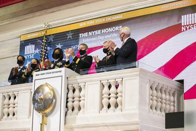 Members of the U.S. Coast Guard, Air Force, Navy and Army ring the opening bell at the New York Stock Exchange on Veterans Day, Wednesday, Nov. 11, 2020, in New York.
