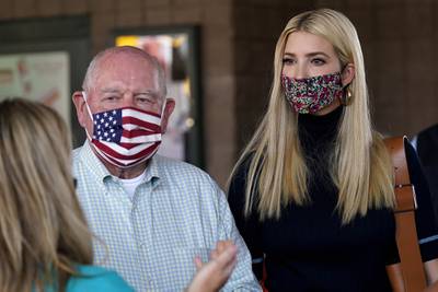 Ivanka Trump, right, and Secretary of Agriculture Sonny Perdue, left, speak with a farming family during a visit to the North Carolina State Farmers Market in Raleigh, N.C., on Sept. 10, 2020.
