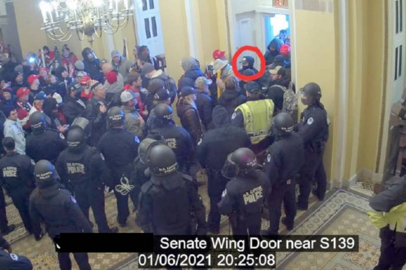 In this image from U.S. Capitol Police video, released and annotated by the Justice Department in the Statement of Facts supporting an arrest warrant, David Elizalde, circled in red, appears on security video inside the U.S. Capitol on Jan. 6, 2021, in Washington.