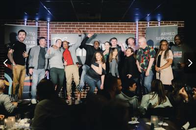 Members of the Armed Services Arts Partnership comedy bootcamp class pose for a photo at their graduation showcase at the DC Improv on May 3, 2023, in Washington, D.C.