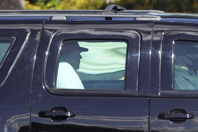President Donald Trump rides in a motorcade vehicle as he departs Trump International Golf Club, Sunday, Dec. 27, 2020, in West Palm Beach, Fla.