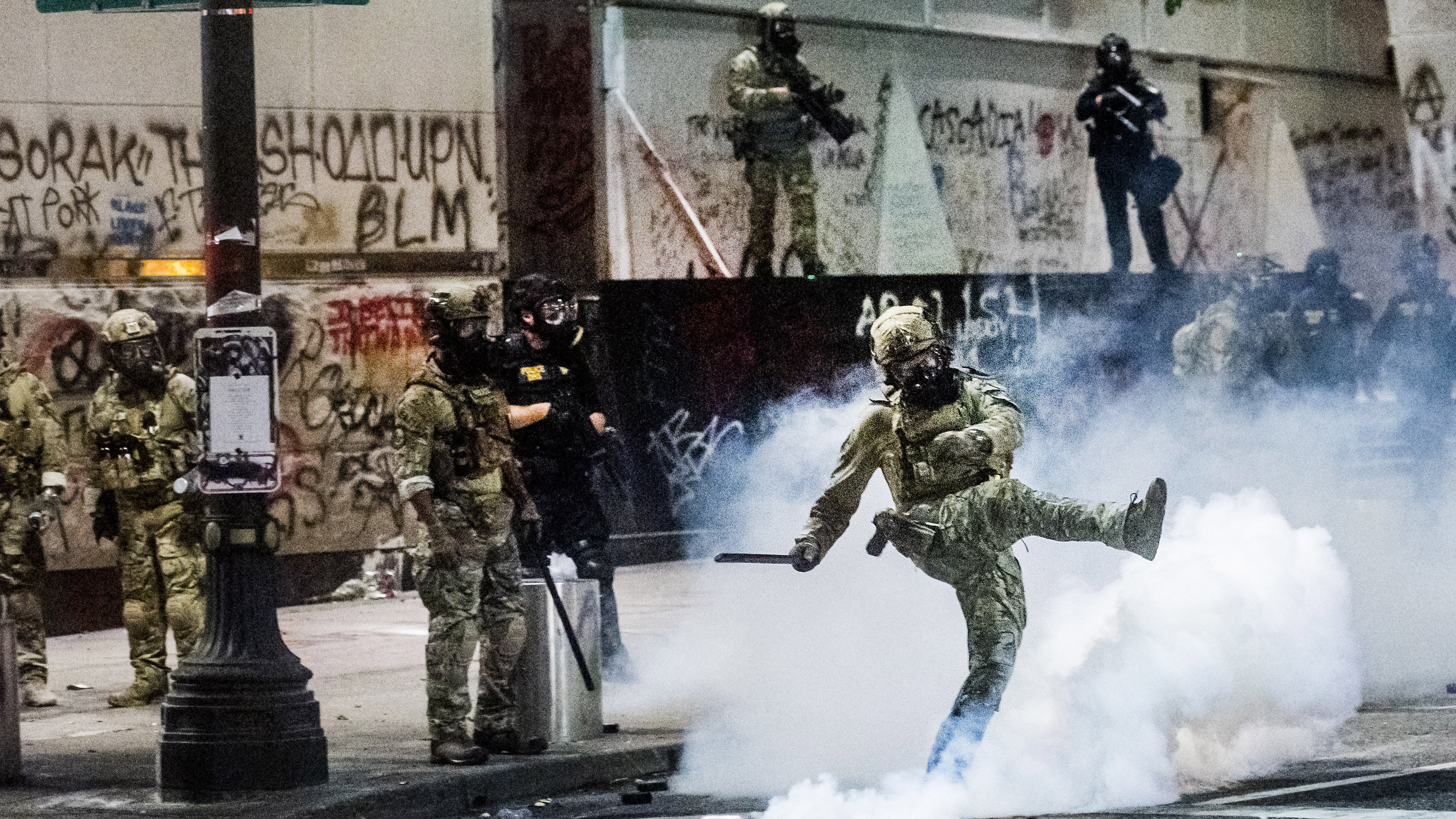 Federal officers use tear gas to disperse BLM protestors.