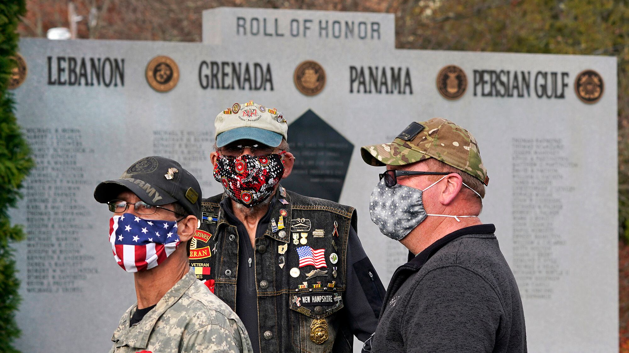 Veterans, wearing protective masks due to the COVID-19 virus outbreak, gather during a Veterans Day ceremony, Wednesday, Nov. 11, 2020, in Derry, N.H.