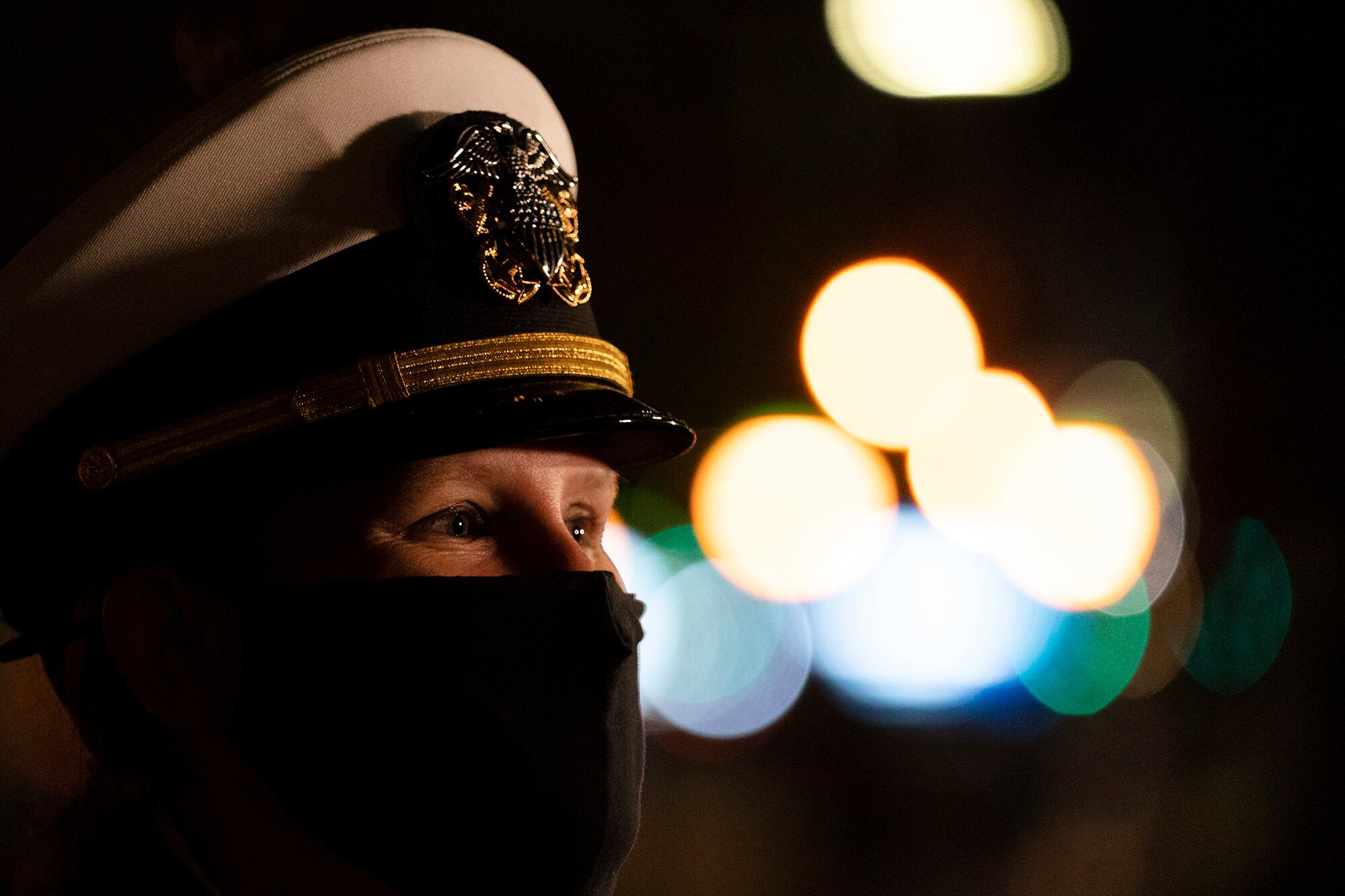 A Navy officer joins in a wreath-laying ceremony at the Eternal Light Flagstaff in Madison Square Park, Wednesday, Nov. 11, 2020, in New York.